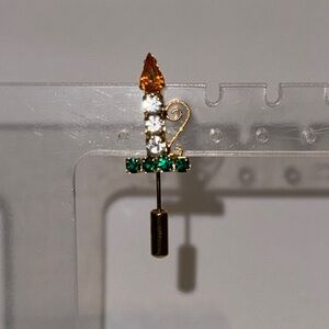 Elegant Gold and Green Brooch with Candle Design